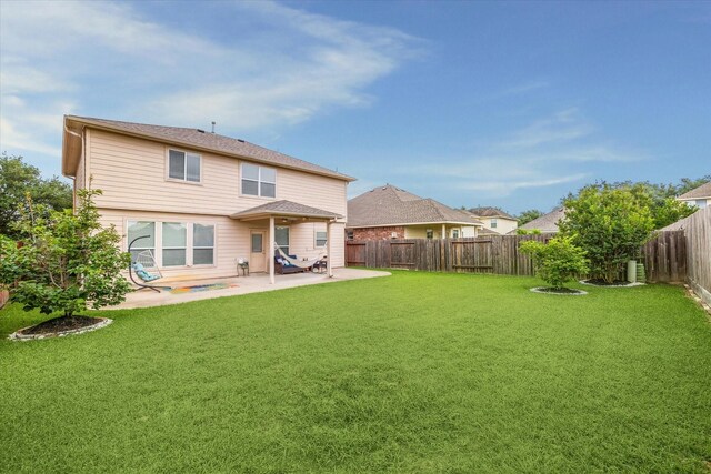 back of property featuring a lawn, a fenced backyard, and a patio area