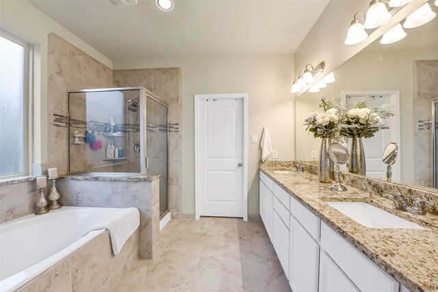full bath with a sink, double vanity, a shower stall, and a bath