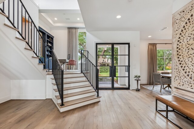 entrance foyer with recessed lighting, baseboards, stairs, and wood finished floors