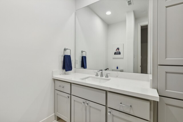 bathroom with vanity and visible vents