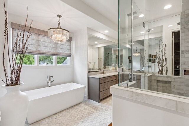bathroom with vanity, visible vents, a chandelier, a soaking tub, and a shower stall