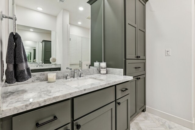 full bath featuring baseboards, a shower with shower door, vanity, and recessed lighting