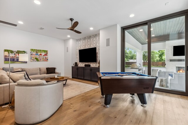 game room featuring a fireplace, light wood-style floors, a ceiling fan, recessed lighting, and visible vents