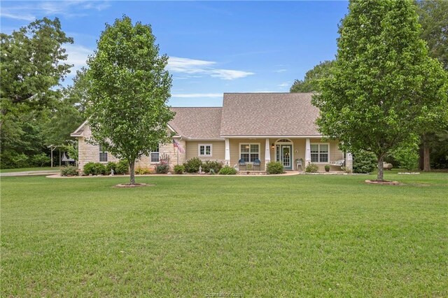 single story home with roof with shingles and a front yard