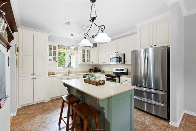 kitchen featuring a sink, appliances with stainless steel finishes, baseboards, and white cabinetry