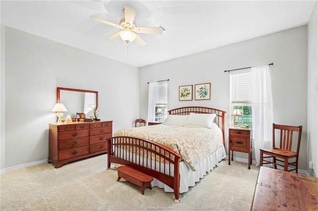 bedroom featuring baseboards, light carpet, and a ceiling fan