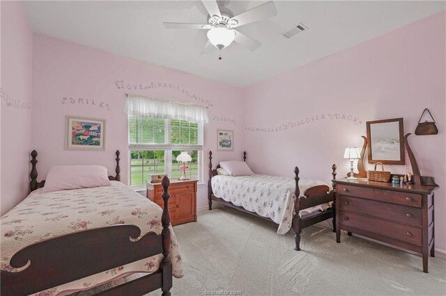 bedroom featuring ceiling fan, light colored carpet, baseboards, and visible vents