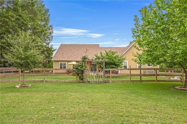 view of yard featuring fence and a pergola