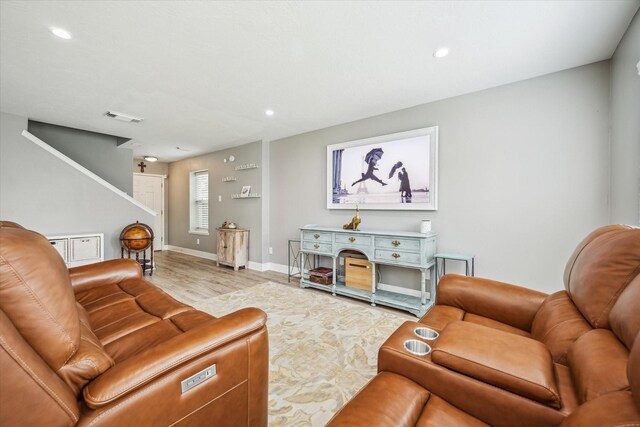 living area featuring stairs, recessed lighting, visible vents, and light wood finished floors