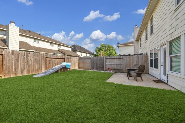 view of yard with a fenced backyard and a patio area