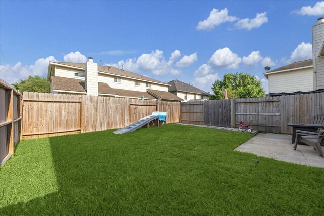view of yard featuring a patio and a fenced backyard
