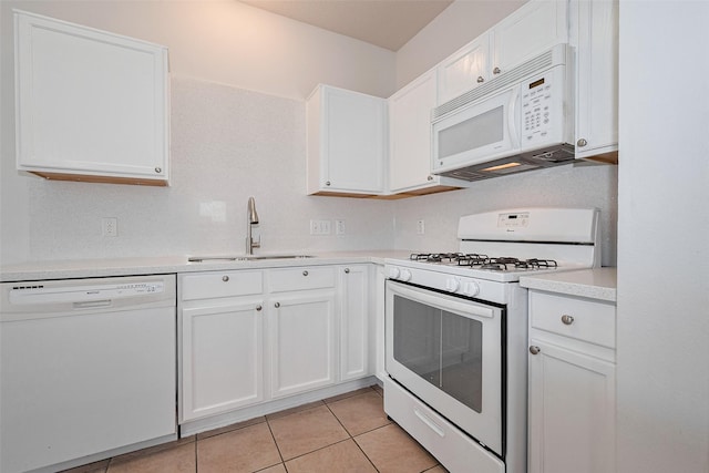 kitchen with a sink, white appliances, and white cabinetry