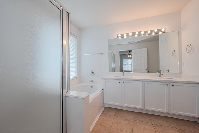bathroom with a sink, tile patterned floors, a shower stall, and a bath