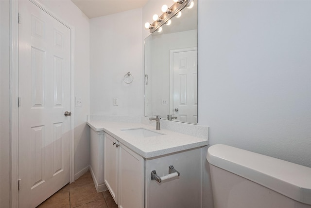 half bath featuring toilet, tile patterned flooring, and vanity