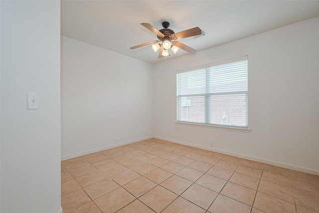 empty room featuring baseboards, a ceiling fan, light tile patterned floors, and visible vents