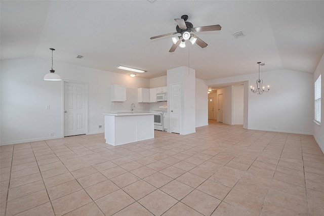unfurnished living room with ceiling fan with notable chandelier, baseboards, vaulted ceiling, and light tile patterned flooring