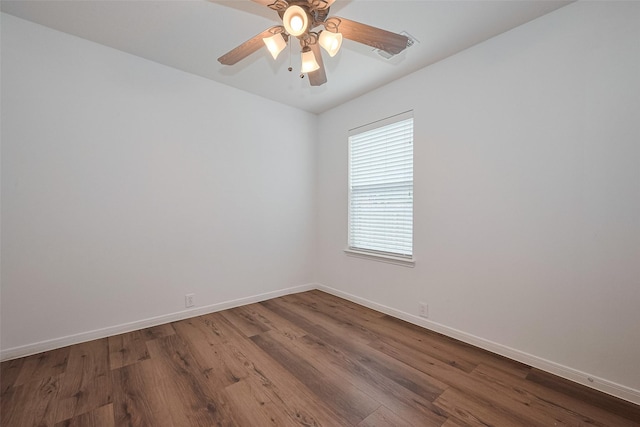 unfurnished room featuring dark wood-type flooring, baseboards, and ceiling fan