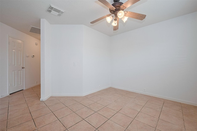 empty room featuring visible vents, baseboards, ceiling fan, and light tile patterned floors