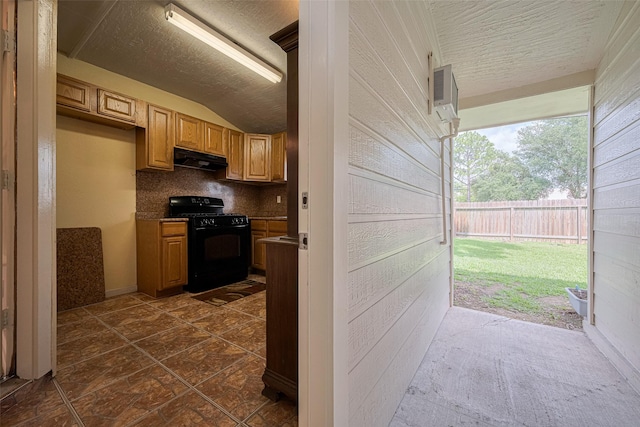526 Majestic Ridge Dr, Houston, TX 77049 - kitchen with black gas range, decorative backsplash, a textured ceiling, under cabinet range hood, and vaulted ceiling