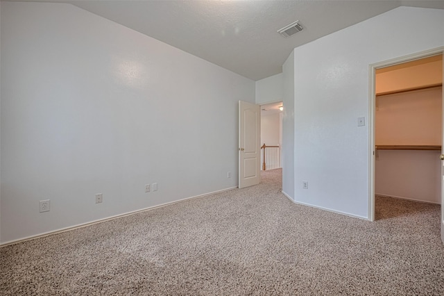526 Majestic Ridge Dr, Houston, TX 77049 - unfurnished bedroom with vaulted ceiling, carpet, and a spacious closet