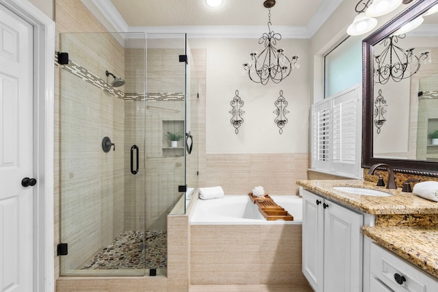 bathroom featuring vanity, ornamental molding, a stall shower, and a bath