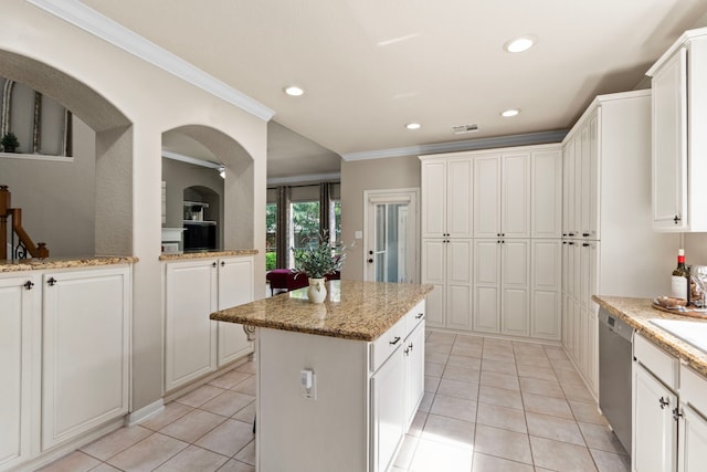 kitchen featuring crown molding, white cabinets, stainless steel dishwasher, and light tile patterned flooring