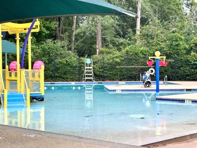 community pool featuring a water play area
