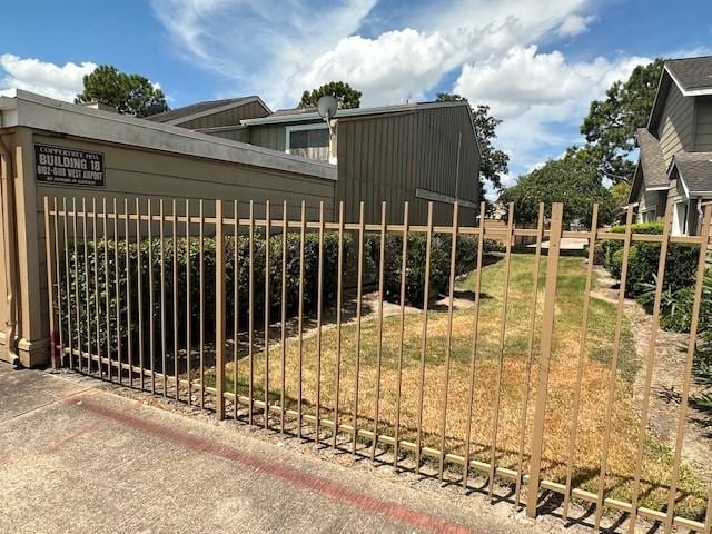 view of gate featuring a yard and fence