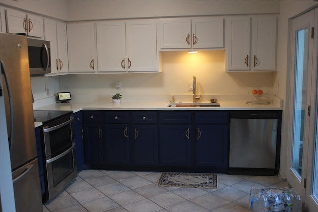 6106 W Airport Blvd Unit 18, Houston, TX 77035 - kitchen with stainless steel appliances, a sink, light countertops, white cabinetry, and light tile patterned flooring