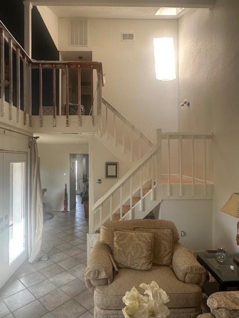 6106 W Airport Blvd Unit 18, Houston, TX 77035 - living area with light tile patterned flooring, stairway, and a towering ceiling