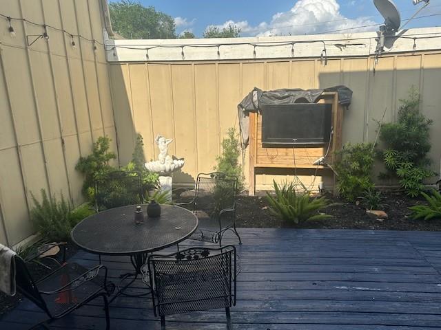 6106 W Airport Blvd Unit 18, Houston, TX 77035 - wooden deck with outdoor dining area