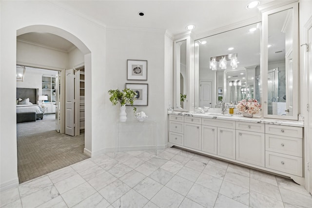 ensuite bathroom with crown molding, connected bathroom, vanity, marble finish floor, and recessed lighting