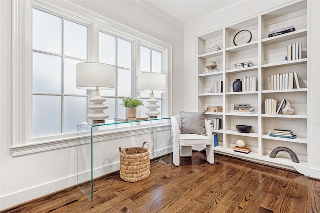living area featuring ornamental molding, built in features, and wood finished floors