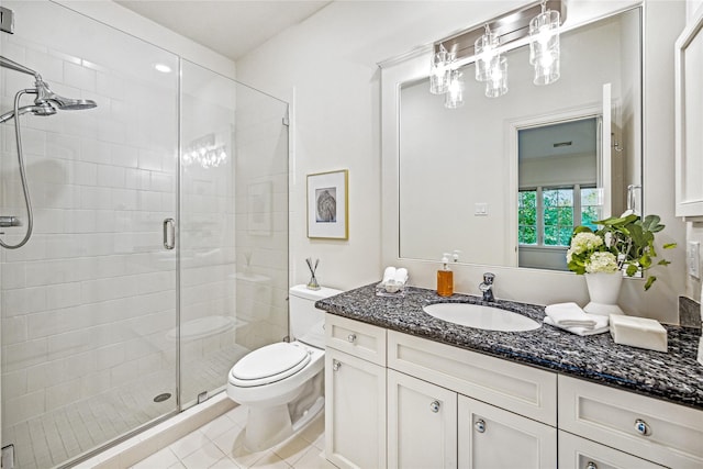 full bath with vanity, tile patterned floors, a shower stall, and toilet