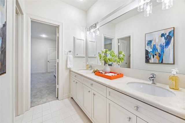 full bath with a sink, baseboards, tile patterned flooring, and double vanity