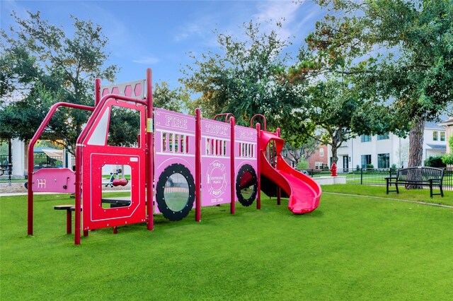 view of play area with a lawn and fence