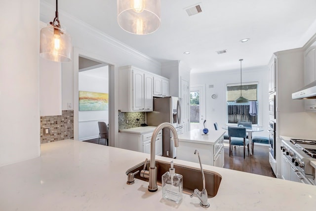 1267 Sopris Dr, Houston, TX 77077 - kitchen with a sink, a center island, light countertops, tasteful backsplash, and appliances with stainless steel finishes