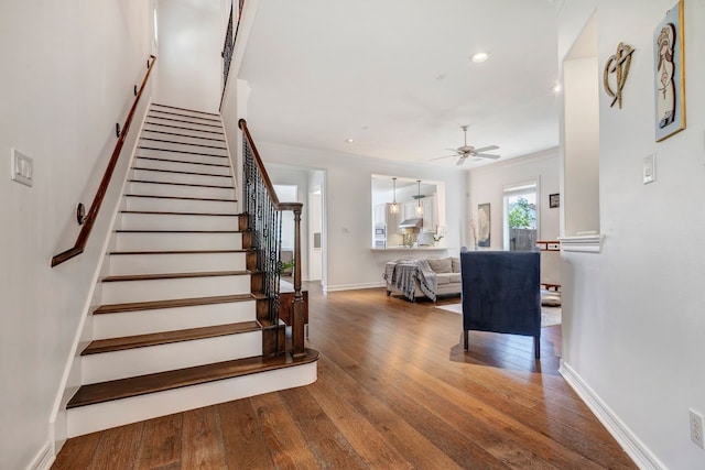 1267 Sopris Dr, Houston, TX 77077 - stairway featuring ceiling fan, hardwood / wood-style flooring, baseboards, recessed lighting, and crown molding