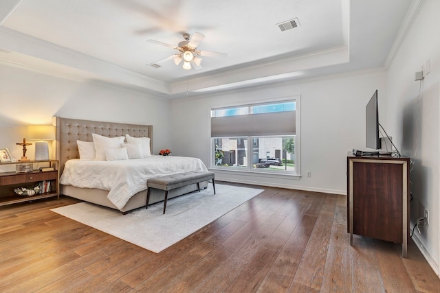 1267 Sopris Dr, Houston, TX 77077 - bedroom featuring a tray ceiling, hardwood / wood-style flooring, crown molding, ceiling fan, and baseboards