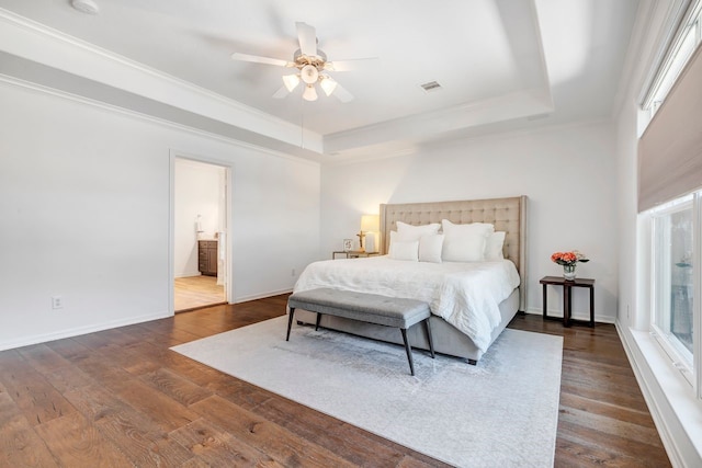 1267 Sopris Dr, Houston, TX 77077 - bedroom with a tray ceiling, dark wood finished floors, baseboards, ornamental molding, and ensuite bathroom