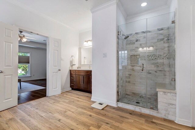 1267 Sopris Dr, Houston, TX 77077 - bathroom with hardwood / wood-style flooring, crown molding, vanity, a shower stall, and ceiling fan