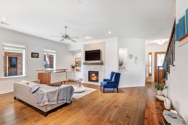 1267 Sopris Dr, Houston, TX 77077 - living room with crown molding, a ceiling fan, a fireplace, hardwood / wood-style flooring, and healthy amount of natural light