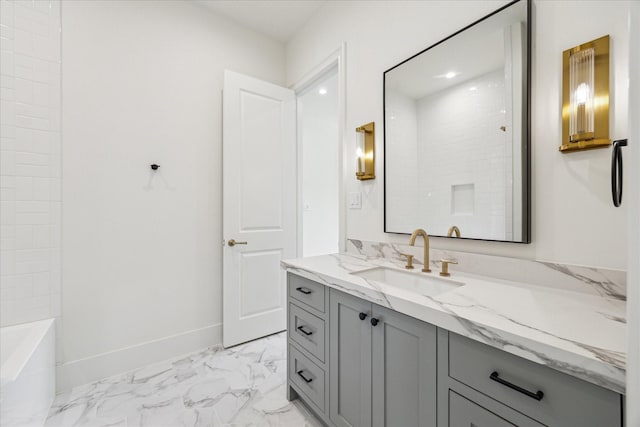 full bath featuring marble look tiles, vanity, a tub to relax in, a shower, and baseboards