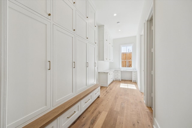 mudroom featuring light wood-style flooring and recessed lighting