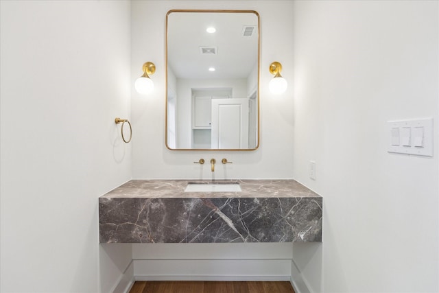 bathroom featuring a sink and wood finished floors