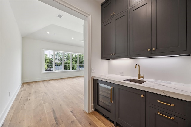 4230 Whitman St, Houston, TX 77027 - bar area with a sink, light wood finished floors, baseboards, beverage cooler, and recessed lighting