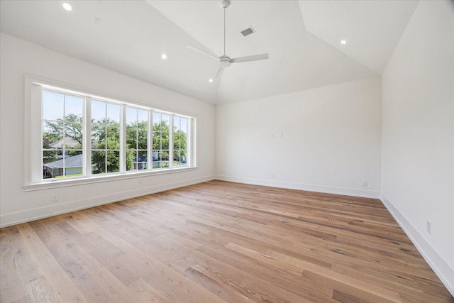 empty room featuring ceiling fan, light wood-type flooring, recessed lighting, baseboards, and high vaulted ceiling