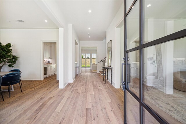 4230 Whitman St, Houston, TX 77027 - hallway featuring light wood-style floors, stairs, baseboards, and recessed lighting