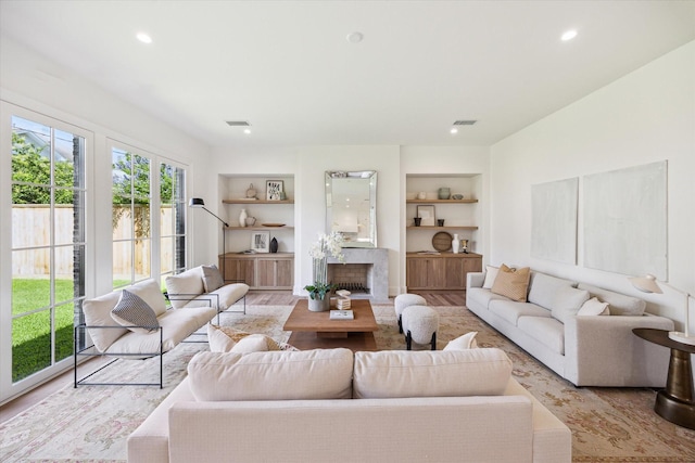 4230 Whitman St, Houston, TX 77027 - living room featuring built in features, recessed lighting, and a premium fireplace