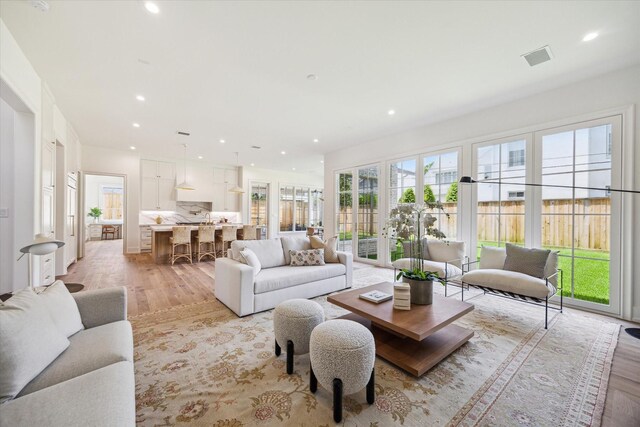 4230 Whitman St, Houston, TX 77027 - living room featuring light wood-type flooring and recessed lighting
